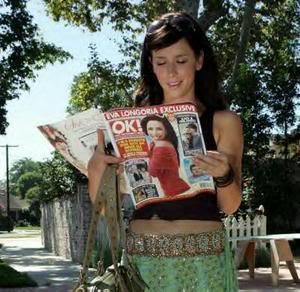 A women is reading OK magazine