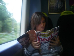 A woman is reading heat magazine