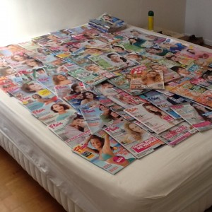 Fashion magazines covering the bed